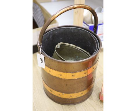 A copper and brass bucket and a lions mask door knocker and a spelter door knocker