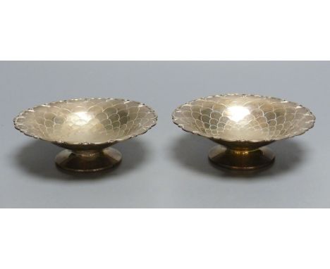 A pair of circular silver sweetmeat tazzas each having scale decoration, shaped rim and circular foot, Sheffield 1957, 15.4cm