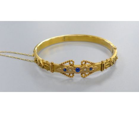 An Edwardian 9ct, sapphire and rose cut diamond chip set hinged bangle, gross 7.7 grams.CONDITION: Probable old professional 