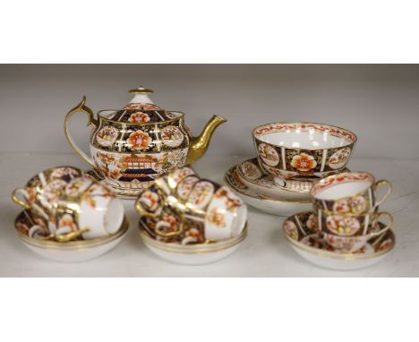 A Spode part tea service painted in imari style with pattern 1956, consisting of a teapot cover and stand, two saucer shaped 