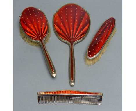 A four-piece silver-gilt and scarlet enamel-mounted dressing table set with fleur de lys decoration, Birmingham 1965