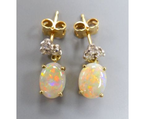 A modern pair of yellow metal, white opal and diamond set drop earrings, 17mm, gross 3.1 grams.CONDITION: Both are in good co