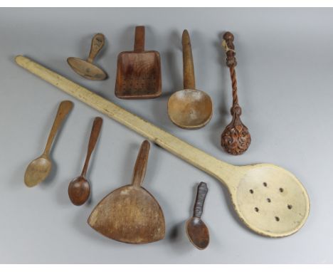 A Beech Wood Skimmer Spoon, 19th Century, and a Selection of Turned Wood Spoons and Scoops, the skimmer 31.25ins overall, a t