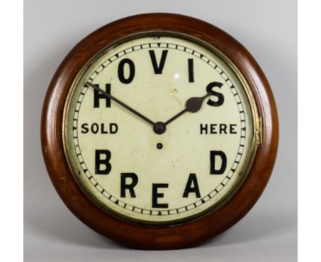 An Early 20th Century Mahogany Cased Dial Wall Clock, the 12ins diameter white enamel dial advertising and worded, "HOVIS BRE