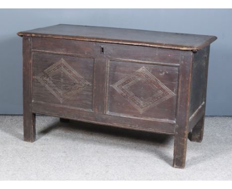 A Late 17th/Early 18th Century Panelled Oak Coffer, the plain lid with moulded edge, the two panel front with chip carved dec
