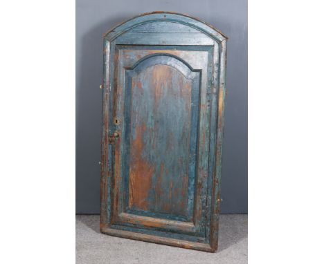 A Late 18th Century Blue Painted Pine Hanging Corner Cupboard with arched and moulded top, fitted three shelves enclosed by a