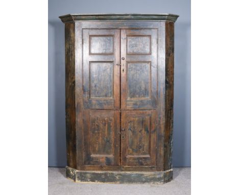 A Late 18th Century Dark Green Painted Pine Two Tier Corner Cupboard, the upper part with deep moulded cornice, the grained w