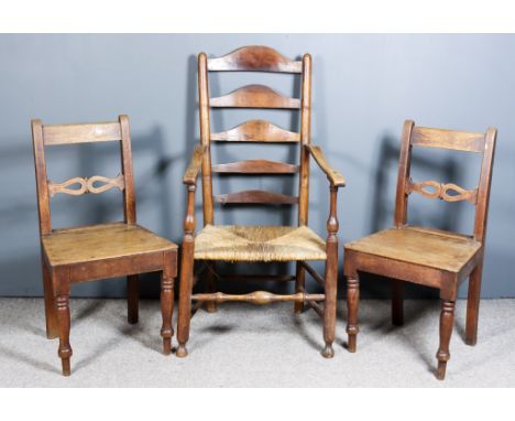 An Early 19th Century Lancashire Ash Ladder Back Armchair, with five shaped splats to back, slightly shaped arms, woven rush 