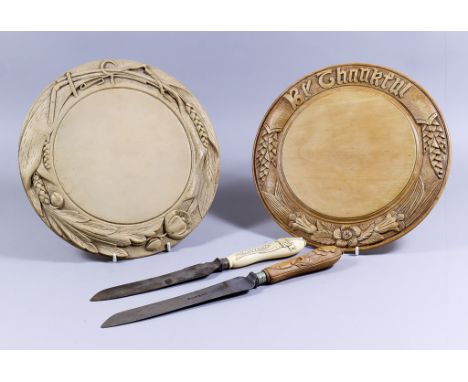 Two Turned and Carved Wood Bread Boards, Late Victorian, one worded "Be Thankful", and carved with wheat and flowers, 11.75in