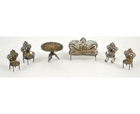 Foreign silver filigree miniature dolls house parlour suite, comprising sofa, armchair, rocking chair and two single chairs, 