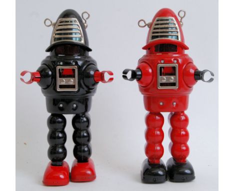 Two tinplate reissue retro Lost In Space Robots both Robby The Robot. One black and the other red. Each measure 21cm long.&nb