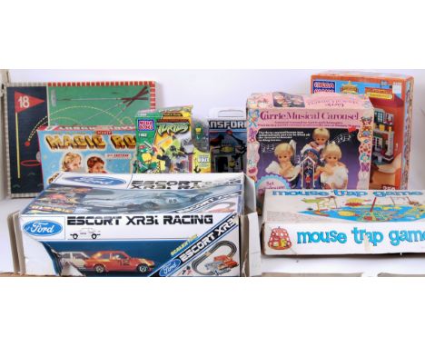A large collection of toys and games to include; a Megabloks western set 9206, Kre-o Transformers, Indoor golf, Mouse Trap, T