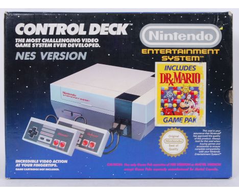 An original Nintendo Entertainment System NES games console Control Deck including 2x controllers. Appears to be complete.&nb