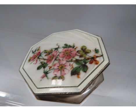 A Birmingham hallmarked silver compact with pretty enamel flower design to top 