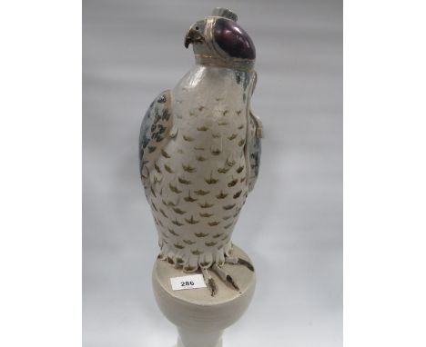 An unusual table lamp in the form of a hooded falcon on stand 