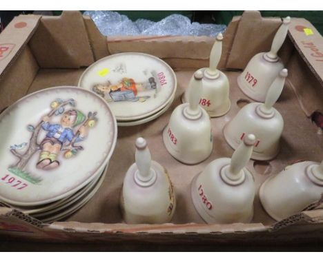 A tray of Goebel year plates together with seven Goebel year bells 