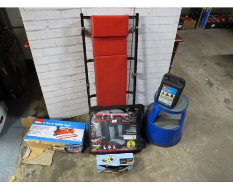 A selection of mechanics items to include boxed jacks, a crawler trolley, tyre pump, car seat covers etc