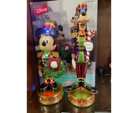 A set of Christmas Disney Mickey Mouse and Goofy nutcracker figures with lights and music, boxed new / old stock, working at 