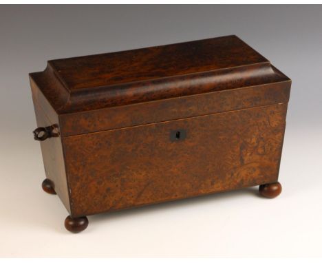 A William IV burr yew tea caddy, of sarcophagus form, the hinged cover opening to a pair of conforming lidded canisters and a
