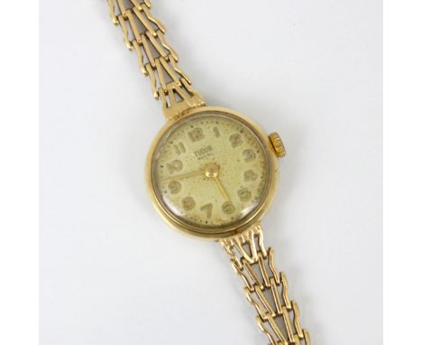 A ladies yellow metal Tudor Royal wristwatch, the circular cream coloured dial with Arabic numerals, set to plain polished ca