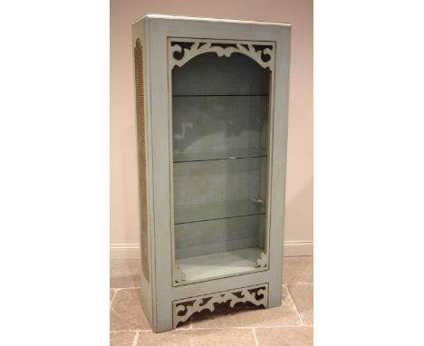 A Chinese influence painted hardwood and rattan open bookcase, late 20th century, the cane work side panels and carved foliat
