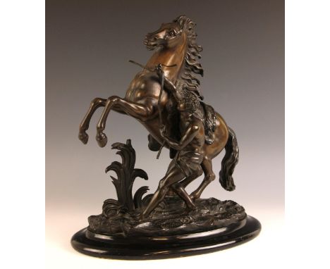 After Guillaume Coustou The Elder (French, 1677-1746), a bronze patinated spelter Marly horse of large proportions, 19th cent