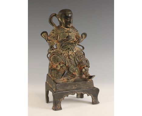 A Chinese bronze model of Emperor Xuan Wu, 18th/19th century, modelled seated wearing elaborate flowing robes with a tortoise