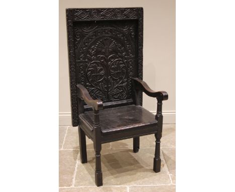 A 17th century and later oak monks bench or adaptable chair, the flip over anthemion carved back rest within a roundel and lo