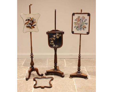 An early Victorian rosewood pole screen, the glazed shield shaped screen enclosing a needlework foliate panel, upon a slender