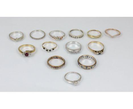 A selection of yellow metal and gold coloured dress rings, including a 9ct ruby and diamond three stone ring, ring size N, a 