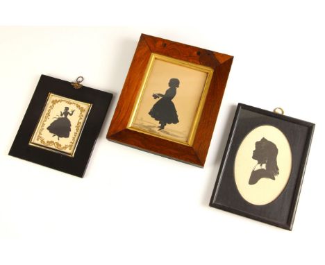 A full length portrait silhouette depicting a lady holding a rose, late 19th or early 20th century, the figure set within a g