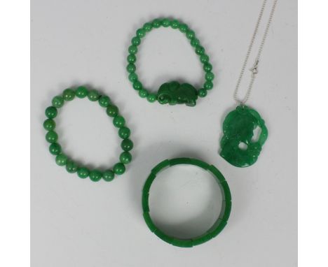 A selection of 'jade' and nephrite jewellery, including a pendant depicting young girl with flower head detail, 5cm long, wit