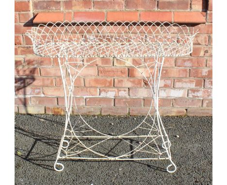A Victorian painted wirework planter, the oblong lattice work  basket, upon four outswept supports applied with batwing spand