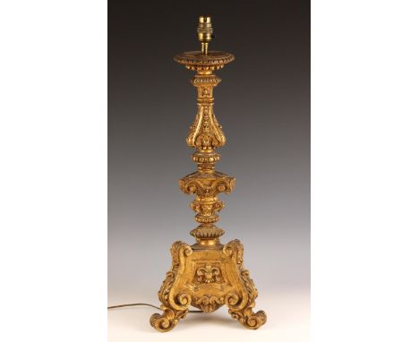 A giltwood pricket form table lamp, the knopped and beaded column upon a triform base with three acanthus scroll feet, 65cm h