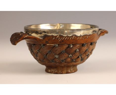 A Victorian Scottish white metal-mounted carved wooden Quaich in the manner of Ferguson and MacBean of Inverness, late 19th o