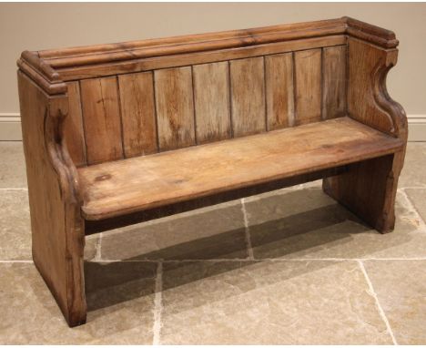 A Victorian pitch pine pew, the shaped and chamfered end supports united by a board seat and back rest, 80cm H x 137cm W x 44