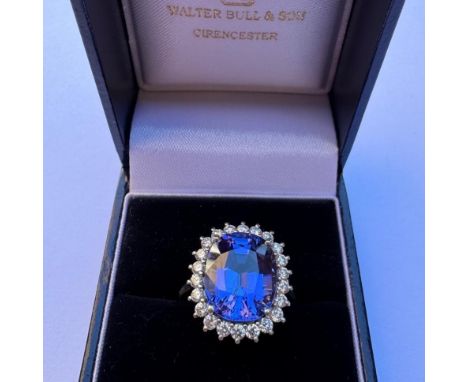 A certified natural tanzanite and diamond cluster ring, circa 1970's, the mixed cut tanzanite within surround of twenty two b