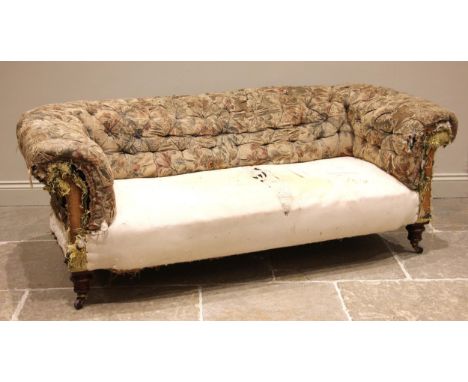 A late 19th century Chesterfield sofa, possibly Howard & Sons, the button down scroll back over a sprung seat, upon turned an