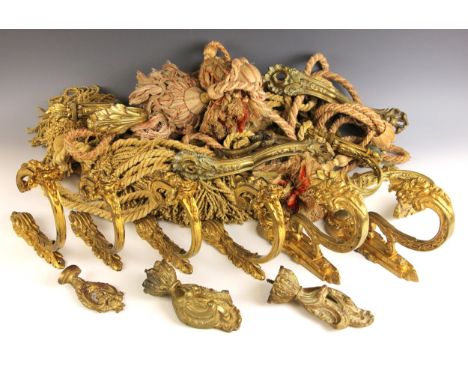 Four pairs of ormolu curtain tie-back brackets, to include two matching pairs with floral detail, each 22cm high, and a pair 