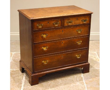 A George III oak chest of drawers, formed with an arrangement of two short and three graduated long, cock beaded and pine lin