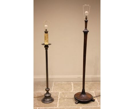 An Art Deco stained hardwood standard lamp, the tapering octagonal column upon a circular plinth base and three out set feet,