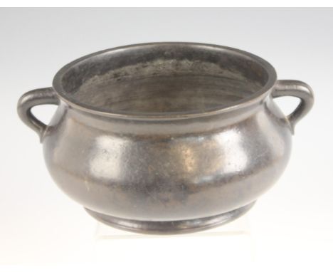 A Chinese bronze censer, Xuande mark but Qing, of raised circular form with flared rim, flanked by loop handles, plain polish