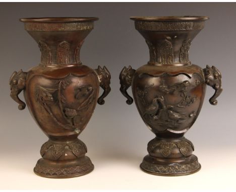 A pair of Japanese bronze vases, Meiji Period (1868-1912), each of baluster form and decorated in relief with birds perched u
