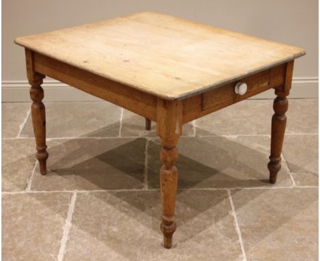 A Victorian pine kitchen table, the moulded plank top over a single frieze drawer applied with a ceramic handle, upon turned 