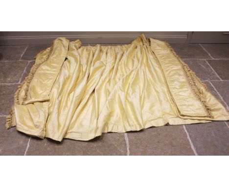 A yellow silk interlined curtain with plain white backing, drop 195cm, the gathered top edge approximately 150cm; with two pe