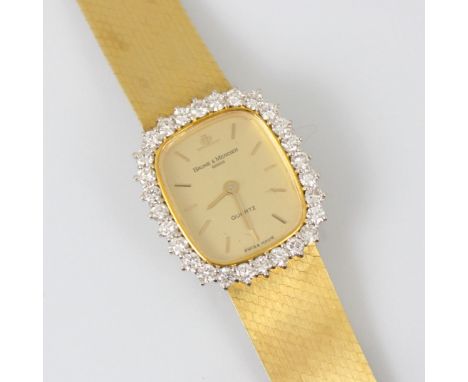A ladies 18ct yellow gold diamond Baume and Mercier quartz wristwatch, the shaped gold coloured rectangular dial with baton m