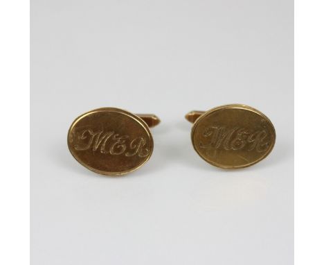 A pair of late 20th century cufflinks, the oval head with engraved initials to centre, toggle backs to reverse, stamped 'JN' 