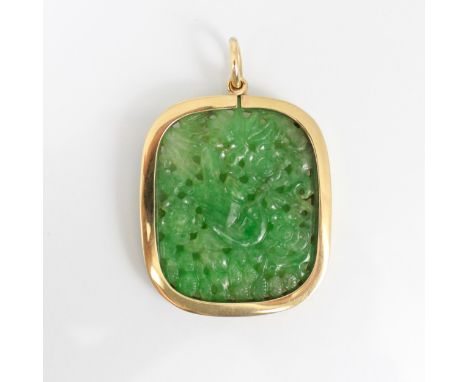 An early 20th century jade pendant, the carved shaped rectangular panel depicting a bird amongst foliage, mounted in yellow m