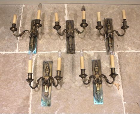 A set of five Adam style neoclassical brass wall sconces, early 20th century, each cast with a flaming urn over a pair of 'S'