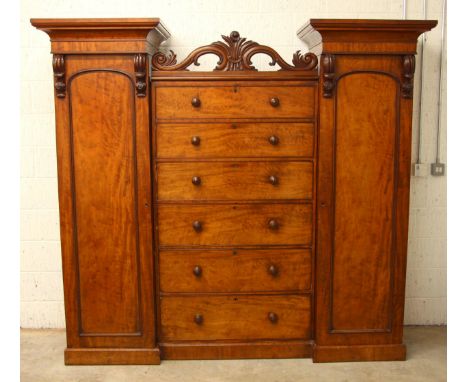 A Victorian mahogany gentleman's sentry wardrobe, of inverted breakfront form, the central bank of six cedar lined graduated 